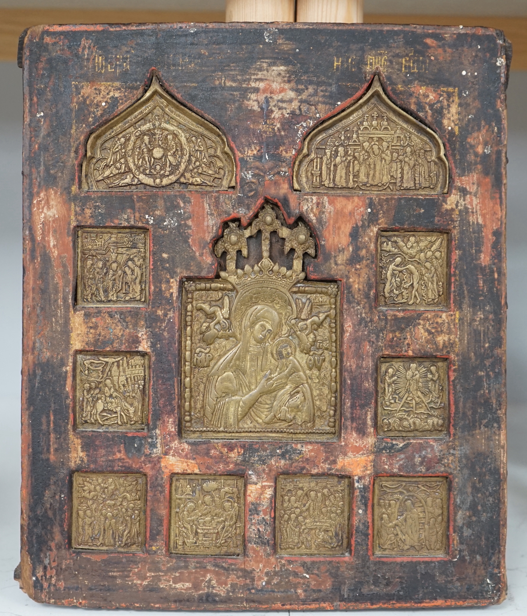 19th century Russian school, Icon with inset brass panels, The Virgin Mary and Child, incised inscription and stamp verso, 31 x 26cm